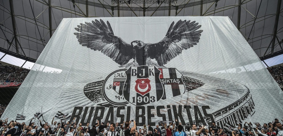 Supporters of Besiktas football club cheer on their team before the start of the Turkish Spor Toto Super league football match between Besiktas and Bursaspor at vodafone arena stadium on April 11, 2016 in Istanbul.  Besiktas football team play its first game at their new vodafone Arena stadium since its inauguration on April 10.   / AFP PHOTO / OZAN KOSE